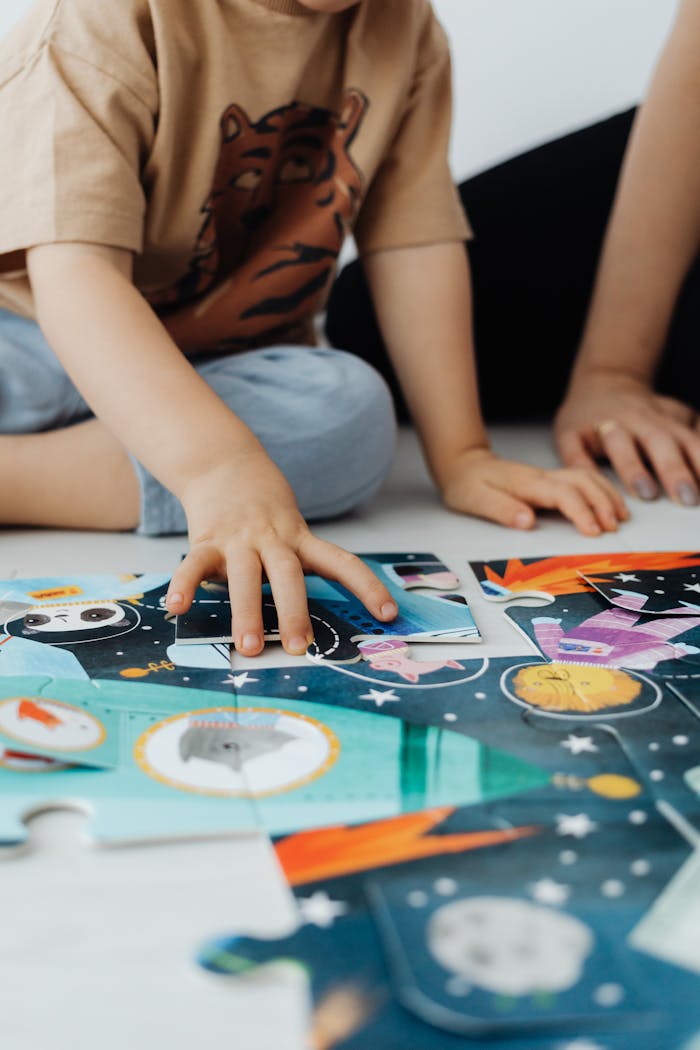 A mother and child enjoy quality bonding time by solving a colorful space-themed puzzle together.